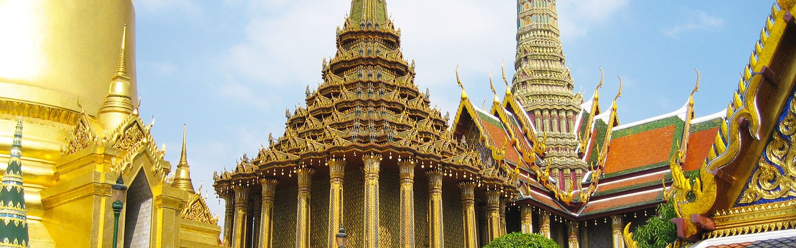 An ornately-decorated building, mostly gold colored, with steep spires.